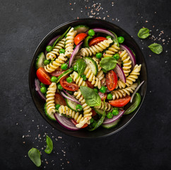 pasta salad with tomato, cucumber, spinach and grean peas