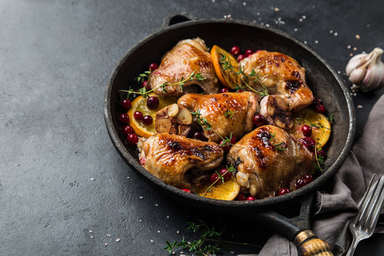 roasted  chicken with orange, cranberry and spicy herbs on pan