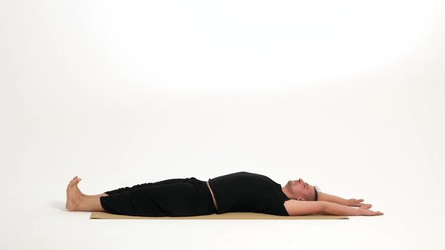 Man demonstrates stretching exercises on a yoga mat against a white background