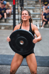 Fototapeta na wymiar Woman lifting weights at a cross training competition