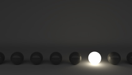 One light sphere among black ones