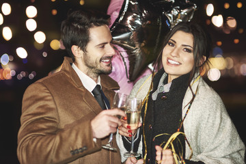 Happy couple toasting to new year .