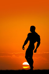 man bodybuilder at sunset