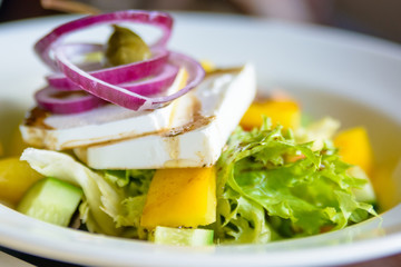Close up plate with Greek salad in restaurant