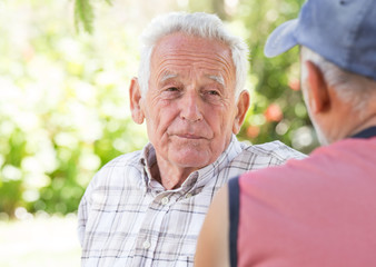 Two senior men talking in park