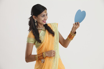 woman holding heart shape