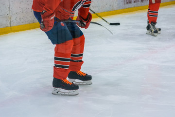 Close up legs of hockey player on ice