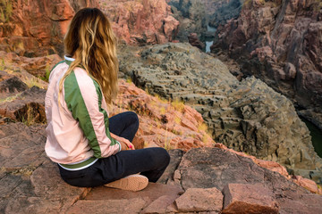 Fototapeta premium Woman meditating in Gharial Sanctuary, India.