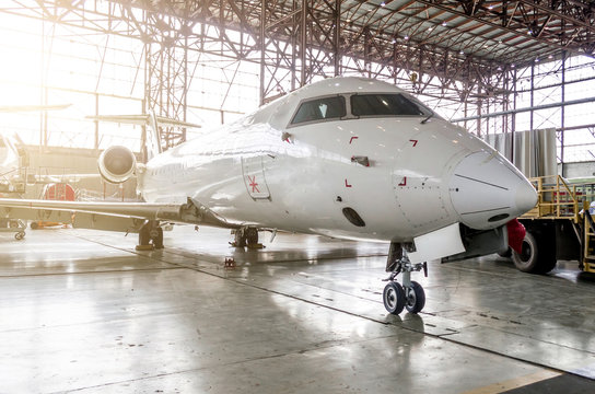 Passenger aircraft in the hangar on service.