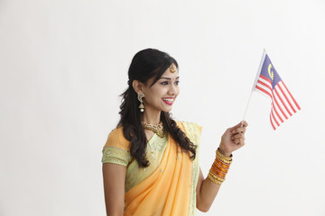 Indian woman in traditional clothing holding flag
