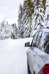 Car in snow-covered winter scenery