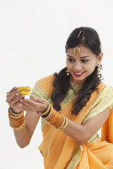 Indian woman in traditional clothing celebrating deepavali