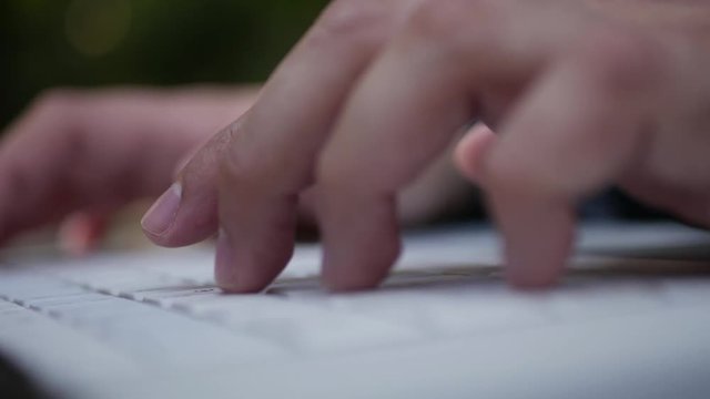 Computer keyboard close-up typing - fingers stroking notebook keys