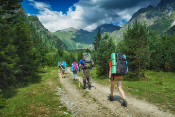 Fototapeta na wymiar Group of hikers climb up to the high mountains