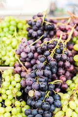 Organic Green and black grape  on  a local farmer market. Healthy local food market concept