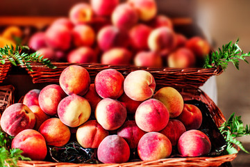 Organic fresh ripe peaches  a local farmer market.  Nectarines on display stall. Healthy local food market concept.