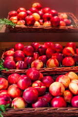 Fototapeta na wymiar Organic fresh ripe peaches a local farmer market. Nectarines on display stall. Healthy local food market concept.