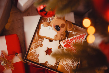 Gingerbread deer new year. Gingerbread on glowing lights of a Christmas tree. Concept of sweets and gifts. top view
