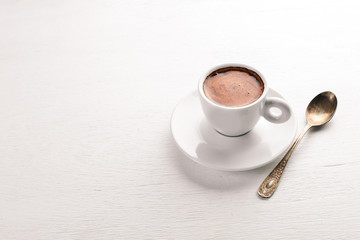 Espresso coffee cup on a white wooden background. Top view. Free space for text.