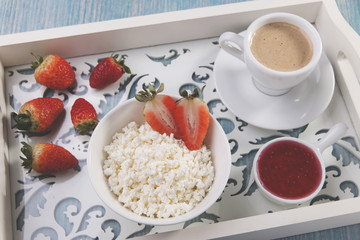 cottage cheese with pieces of strawberries jam and coffee breakfast