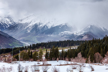 Panoramic view on snow winter mountains and cloud sky. Caucasus Mountains. Svaneti region of Georgia.