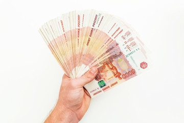 Russian money, banknotes of 5000 rubles in man hand on white background. Flat lay.