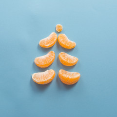 Christmas Art of food still life concept. Christmas tree of tangerine slices.