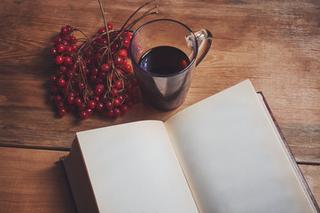 book with branch viburnum and a Cup of tea.