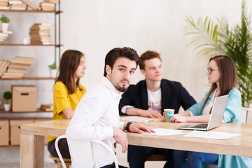 Team of young professionals works together