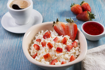 cottage cheese with pieces of strawberries jam and coffee breakfast
