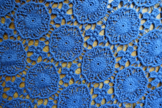 Delicate blue lacy fabric on wood from above
