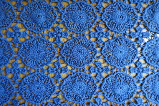 Rustic blue lacy fabric on wood from above