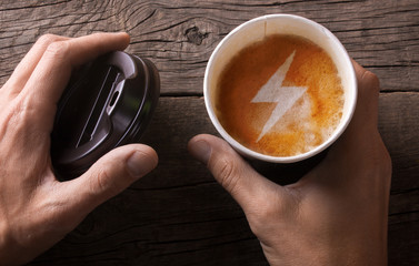 coffee gives energy. Paper cup of coffee is held by a man in his hand
