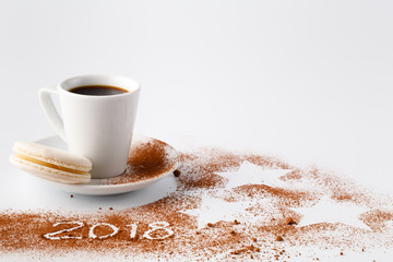 New year of 2018 on cocoa powder with small cup of cocoa