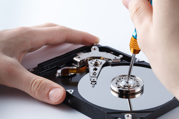 Hard disc drive disassembling close up. Repairman opening hdd for recovery information, service center and electronics repair concept