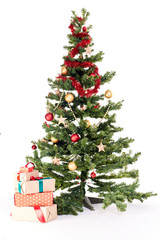 Decorated Christmas tree with heap of gift boxes near it on white background