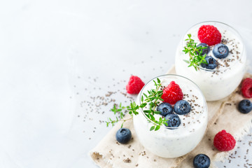 Healthy vegan white chia pudding with berries and green thyme