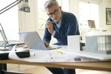 Architect in office working on construction project