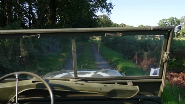 military 4x4 car driving on dirt road