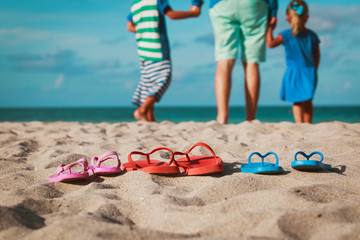 father with son and daughter walking at beach