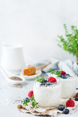 Healthy vegan white chia pudding with berries and green thyme
