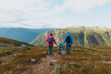 Fototapeta na wymiar family with two kids hiking in mountains, active travel
