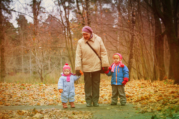 grandmother with kids walk in nature