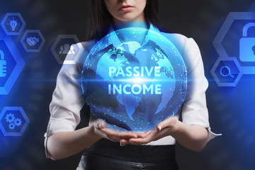 The concept of business, technology, the Internet and the network. A young entrepreneur working on a virtual screen of the future and sees the inscription: Passive income