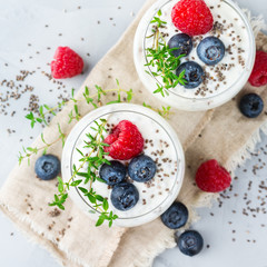 Healthy vegan white chia pudding with berries and green thyme
