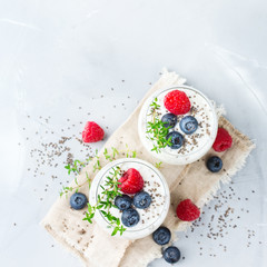 Healthy vegan white chia pudding with berries and green thyme