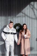 Fototapeta premium Beautiful happy winter christmas style couple have fun outdoor on the street