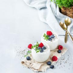 Healthy vegan white chia pudding with berries and green thyme