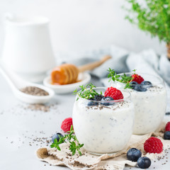 Healthy vegan white chia pudding with berries and green thyme