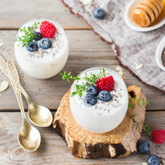 Healthy vegan white chia pudding with berries and green thyme